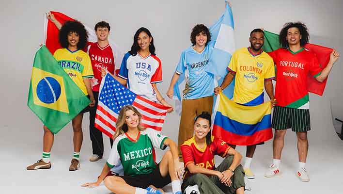 8 young male and females on white background modeling world cup soccer jerseys and country flags